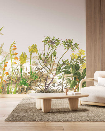 Botanical wallpaper mural featuring delicate South African flora and wildflowers in soft natural tones, with trailing greenery overhead and illustrated aloe, fynbos, and meadow plants across a light background. On a wall in a waiting area.