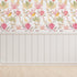 South African fynbos wallpaper pattern with protea flowers, birds and safari animals in an inspired botanical design. Colour is pink delight. On wall in a playroom.