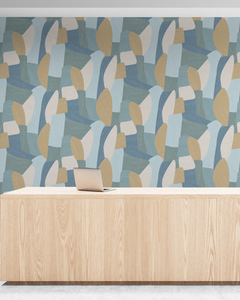 Shades of blues, yellow in abstract shapes with a paint brush texture. On wall in an office reception room.