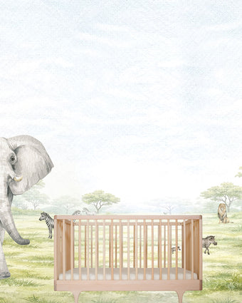 Watercolor safari nursery mural with elephants, giraffes, zebras, lions, warthogs and savannah trees in soft neutral tones. With cot in the centre. 