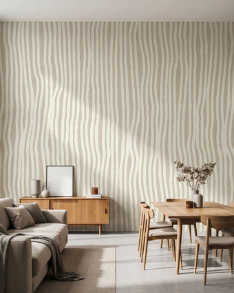 Large custom printed afrocentric geometric mural spilling across a spacious, well-lit living room wall with beige tones and stripe details.