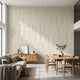 Large custom printed afrocentric geometric mural spilling across a spacious, well-lit living room wall with beige tones and stripe details.