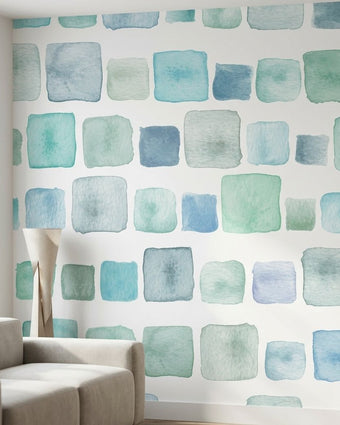 Seamless Aqua Blocks wall mural with pink and teal watercolor geometric pattern in a modern living room.