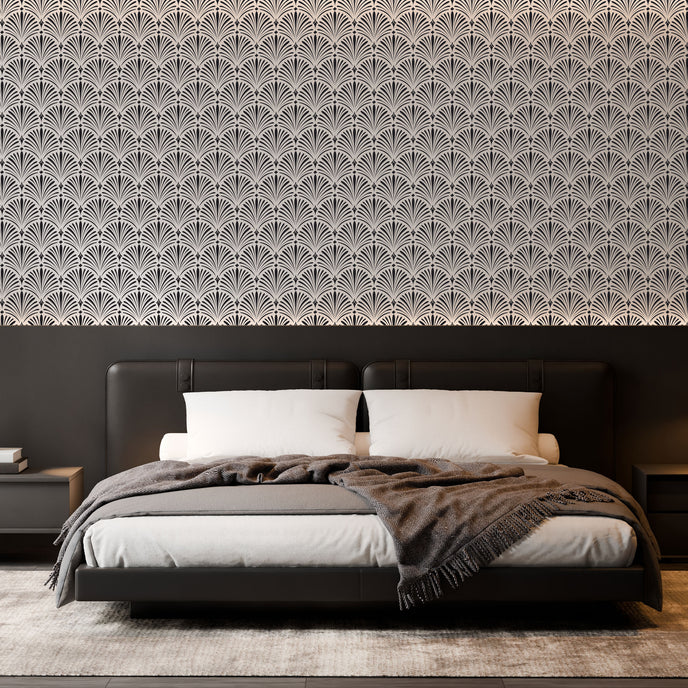Art Deco wallpaper with repeating shell motifs in a black and off-white monochrome pattern. On bedroom wall behind bed. 