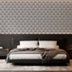 Art Deco wallpaper with repeating shell motifs in a black and off-white monochrome pattern. On bedroom wall behind bed. 