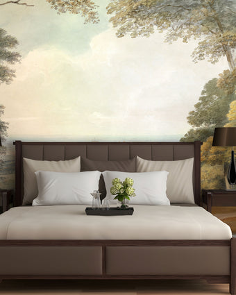 Watercolour landscape mural showing Windsor Castle in the distance, framed by woodland trees and open parkland in soft natural tones. On bedroom wall behind the bed. 