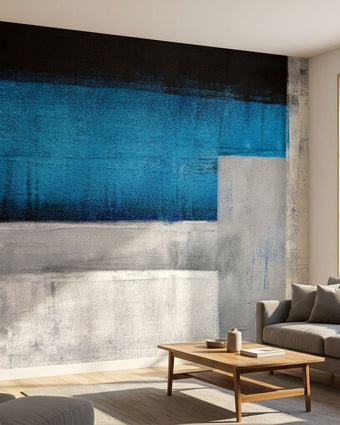 Large blue textured wall mural titled 'Blue Me Away' in a modern living room with natural daylight and contemporary decor.