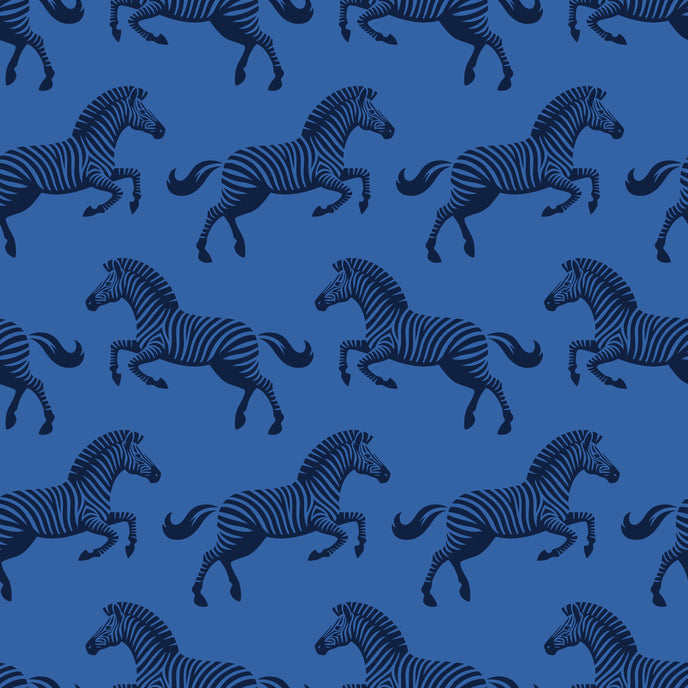 Repeating zebra wallpaper pattern featuring navy and royal blue zebras on a cobalt blue background. Zoomed in on the zebras. 
