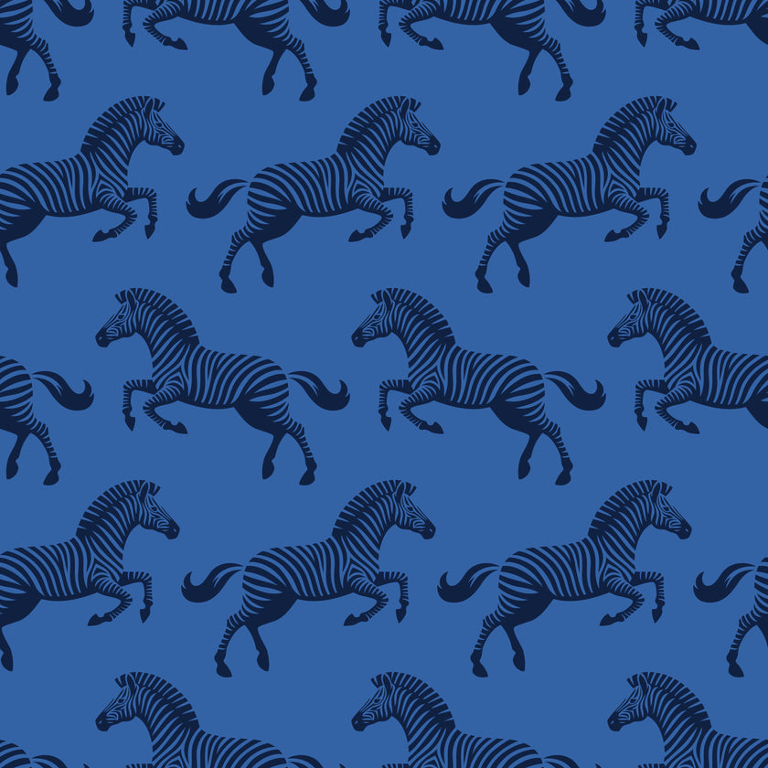 Repeating zebra wallpaper pattern featuring navy and royal blue zebras on a cobalt blue background. Zoomed in on the zebras. 