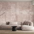 Blush toned forest mural featuring misty woodland trees and soft layered foliage in a dreamy, watercolour inspired style. On a wall in a lounge, behind the beige/cream couch. 