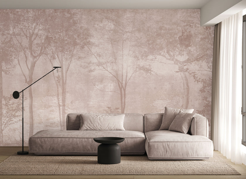 Blush toned forest mural featuring misty woodland trees and soft layered foliage in a dreamy, watercolour inspired style. On a wall in a lounge, behind the beige/cream couch. 