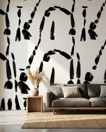 Custom printed Cairn wall mural with African-inspired geometric patterns in black and white, filling a modern living room wall.