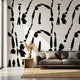 Custom printed Cairn wall mural with African-inspired geometric patterns in black and white, filling a modern living room wall.