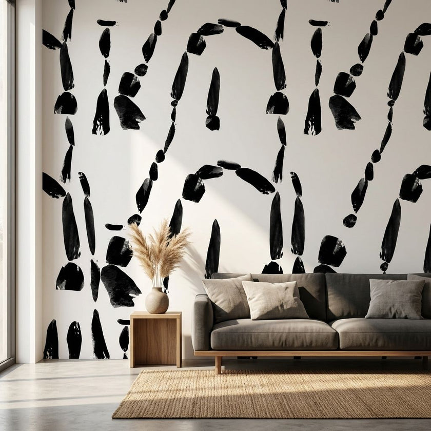 Custom printed Cairn wall mural with African-inspired geometric patterns in black and white, filling a modern living room wall.