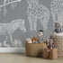 Playful monochrome safari mural for a children’s room with giraffes, monkeys, a zebra, and a gentle big cat among tropical leaves.
