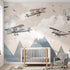 Realistic shot of a child's bedroom with a vivid airplane and mountain landscape mural covering the entire wall.
