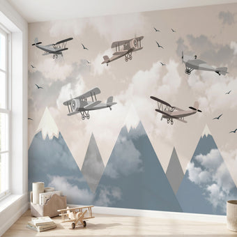 Panoramic view of a child's room wall decorated with a cheerful cartoon airplane flying over colorful mountains mural.