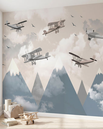 Panoramic view of a child's room wall decorated with a cheerful cartoon airplane flying over colorful mountains mural.