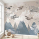 Panoramic view of a child's room wall decorated with a cheerful cartoon airplane flying over colorful mountains mural.