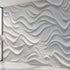 Close-up view of a geometric patterned wall mural with precise, seamless design, displayed on a large wall in a modern setting.