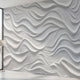 Close-up view of a geometric patterned wall mural with precise, seamless design, displayed on a large wall in a modern setting.