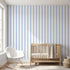 Interior scene with a Baby Blue seamless geometric mural covering the entire wall in a modern nursery space.