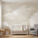 Seamless wall mural in a nursery featuring soft beige clouds on a calm sky, scaled to fit the entire wall with natural lighting.
