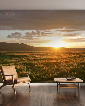 Large mural of a mountain sunset scene covering an entire wall with vibrant warm colors and seamless detail.