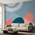 Vibrant 'Drawn In' wall mural with floral and abstract patterns on textured wall in modern living room.