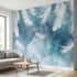 Vibrant blue feather and floral patterned mural covering an entire wall in a modern living room, illuminated by natural daylight.