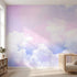 Seamless colorful sky mural extending across a large nursery wall with natural sunlight, highlighting the lively colors and soft textures.