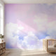 Seamless colorful sky mural extending across a large nursery wall with natural sunlight, highlighting the lively colors and soft textures.