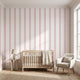 Seamless pink stripe mural filling full wall in stylish nursery with natural sunlight, showcasing pattern accuracy and wall coverage.