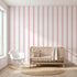 Vibrant seamless pink stripe mural dominating contemporary interior with sleek furniture, emphasizing pattern detail and room coverage.