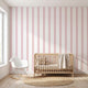 Vibrant seamless pink stripe mural dominating contemporary interior with sleek furniture, emphasizing pattern detail and room coverage.