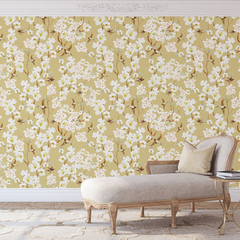 Vintage inspired wallpaper featuring white and blush blossom flowers, winding branches, and swallows in flight on a warm golden-beige background.