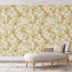 Vintage inspired wallpaper featuring white and blush blossom flowers, winding branches, and swallows in flight on a warm golden-beige background.