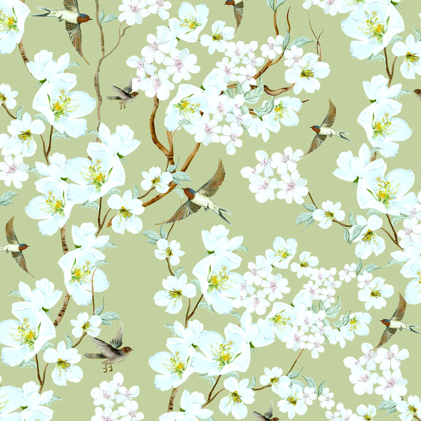 Chinoiserie inspired wallpaper featuring delicate white blossom flowers, flowering branches, and swallows in flight on a soft sage green background.
