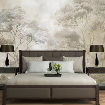 Soft neutral forest wallpaper featuring delicate misty trees in layered sepia and taupe tones with a hand sketched effect. On wall behind the bed.