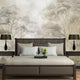Soft neutral forest wallpaper featuring delicate misty trees in layered sepia and taupe tones with a hand sketched effect. On wall behind the bed.