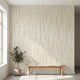 Seamless African-inspired geometric mural covering the entire wall in a modern interior with natural lighting and muted beige colors.