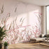 Full view of a pink floral mural covering an entire wall in a modern indoor space, illuminated by warm diffused sunlight.