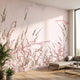 Full view of a pink floral mural covering an entire wall in a modern indoor space, illuminated by warm diffused sunlight.