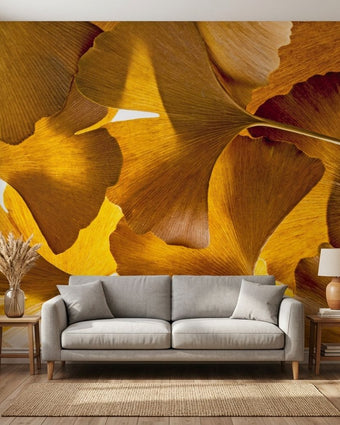 Ginko Balboa botanical wall mural with vibrant gingko leaves in a modern living room setting, seamlessly covering the wall without joins.