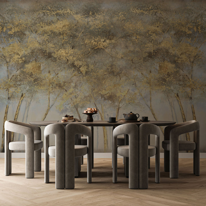Forest mural featuring golden woodland trees with softly textured foliage against a smoky grey background, creating a warm and atmospheric nature inspired scene. On a wall behind a dinning table with dark furniture. 