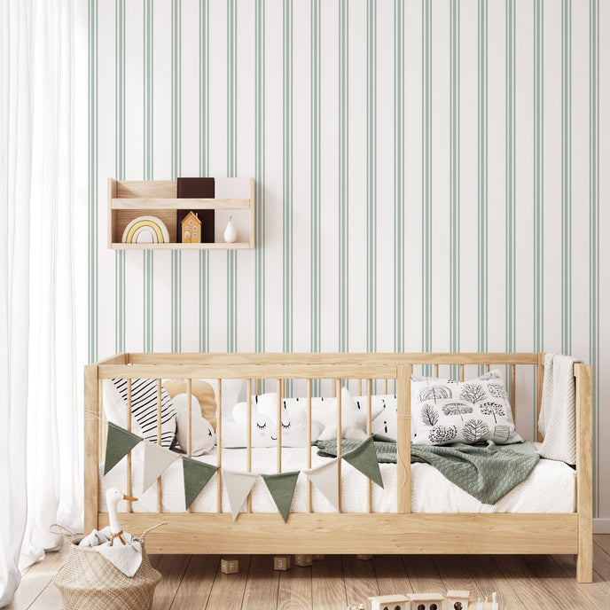 Classic green pinstripe wallpaper with fine vertical stripes, inspired by traditional country house interiors and timeless textile patterns. On kids bedroom wall, behind bed. 