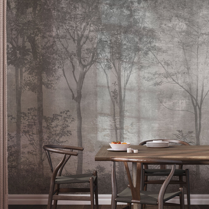 Nature-inspired forest mural featuring misty woodland trees in soft grey tones, creating a calm and atmospheric backdrop for contemporary interiors. On wall in a dinning room, with dark wooden table and chairs. 