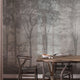 Nature-inspired forest mural featuring misty woodland trees in soft grey tones, creating a calm and atmospheric backdrop for contemporary interiors. On wall in a dinning room, with dark wooden table and chairs. 