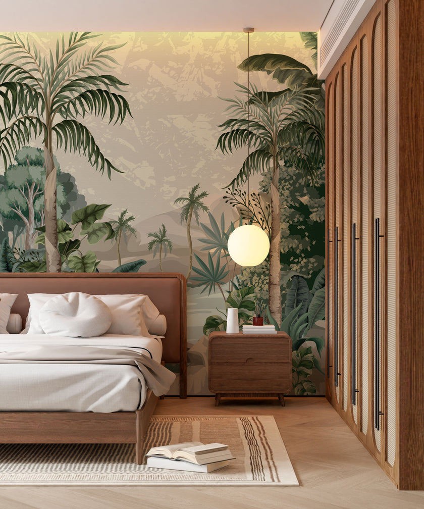 A styled bedroom interior featuring a tropical mural with lush green palms and foliage surrounding a blue lagoon with soft mountains in the background, behind a bed. The room includes a wooden bed frame, white bedding, a matching wooden nightstand with a round white pendant light, a slatted wood wardrobe, and light wood flooring.


