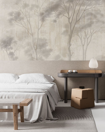 Neutral woodland wallpaper with soft ivory and taupe trees in a misty forest landscape. In a bedroom behind the beds headboard. 